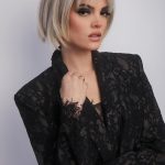 Blonde bob wig with layered cut and side-swept bangs from Hidden Secrets Wigs.